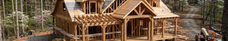 construction site in Central Virginia with framing and wooded lot, emphasizing custom home builders va
